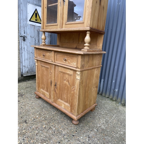 85 - A continental pine two section dresser glazed to the top