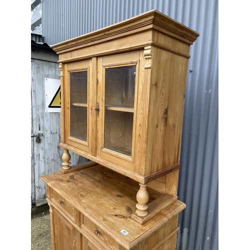 85 - A continental pine two section dresser glazed to the top