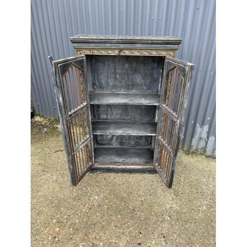 89 - A painted cabinet with metal grill front