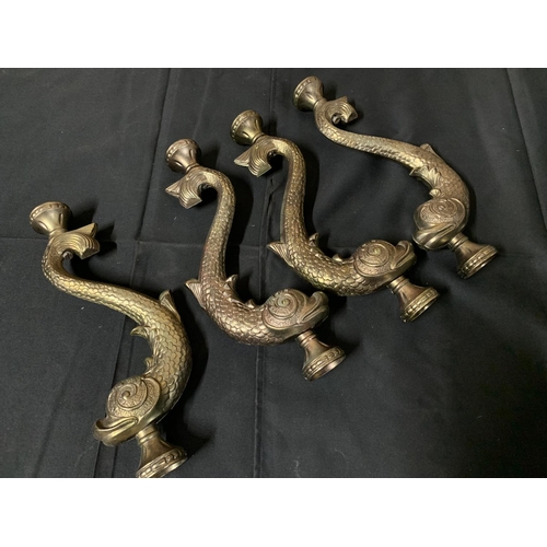 957 - Four brass Dolphin supports each 42 cms high