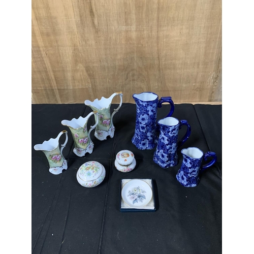 961 - Two sets graduated Jugs and trinket pots