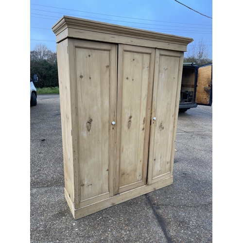 113 - A continental pine three door wardrobe 155x50x205