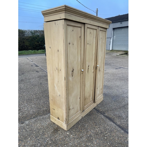 113 - A continental pine three door wardrobe 155x50x205