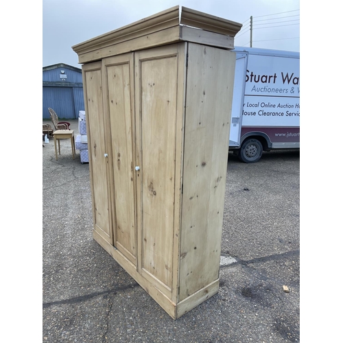 113 - A continental pine three door wardrobe 155x50x205