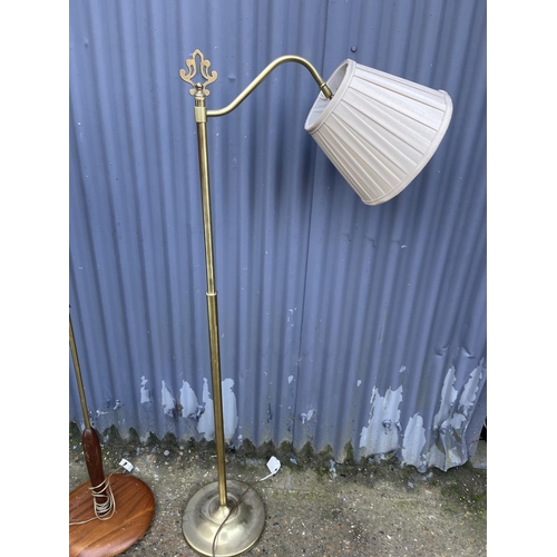 114 - A teak floor standing lamp together with two others