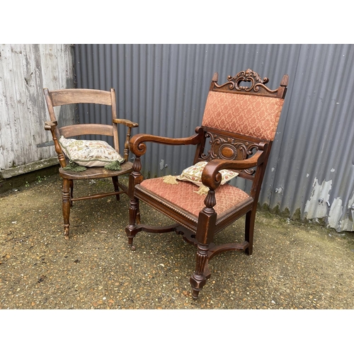 12 - A carved oak carver chair together with a Windsor style kitchen chair