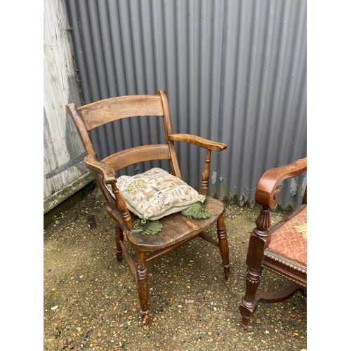 12 - A carved oak carver chair together with a Windsor style kitchen chair