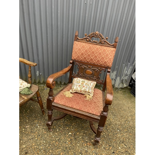 12 - A carved oak carver chair together with a Windsor style kitchen chair