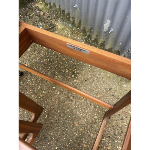 121 - A mid century teak trolley nest of three tables with fold over top