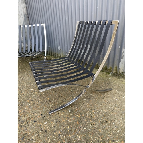 124 - A pair of chrome framed Barcelona chairs with cushions for reupholstery