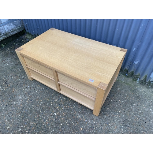 131 - A modern light oak four drawer coffee table 100x 60x50