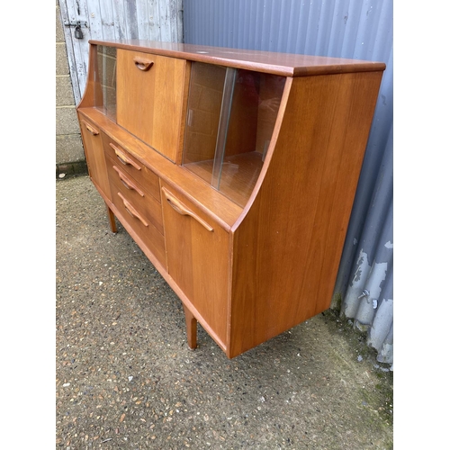 135 - A mid century teak sideboard with drop down cocktail compartment 167cm wide