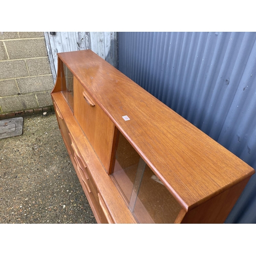 135 - A mid century teak sideboard with drop down cocktail compartment 167cm wide