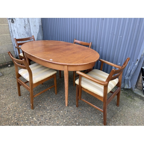 136 - A mid century oval teak table  and four chairs