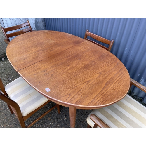 136 - A mid century oval teak table  and four chairs