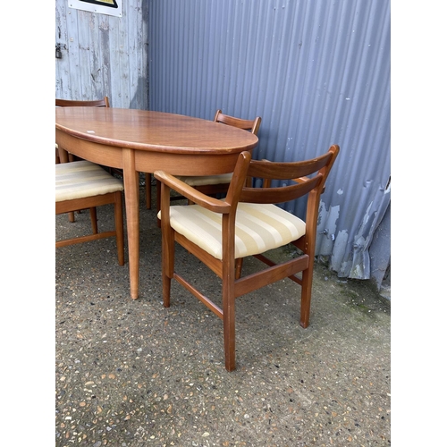 136 - A mid century oval teak table  and four chairs