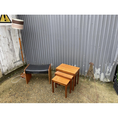 15 - A retro teak nest of three together with a teak standard lamp, dressing table stool, and a clock