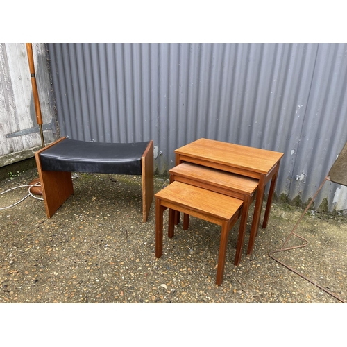 15 - A retro teak nest of three together with a teak standard lamp, dressing table stool, and a clock