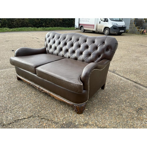 153 - A brown leather chesterfield club style two seat sofa