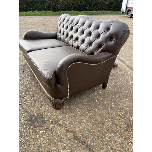 153 - A brown leather chesterfield club style two seat sofa