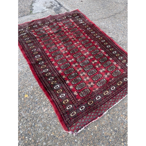 156 - A red oriental pattern rugb126x175