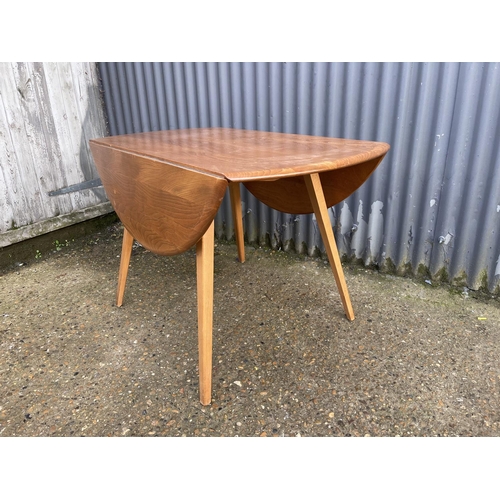 159 - An ercol light elm drop leaf kitchen table