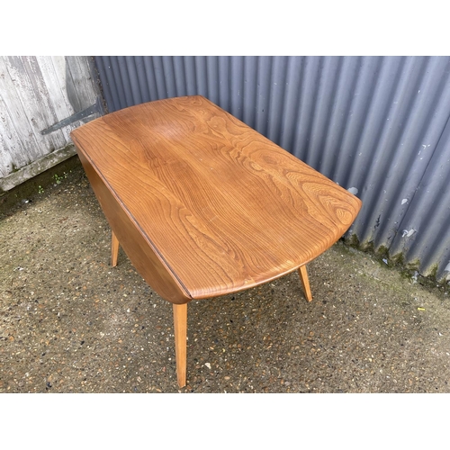 159 - An ercol light elm drop leaf kitchen table