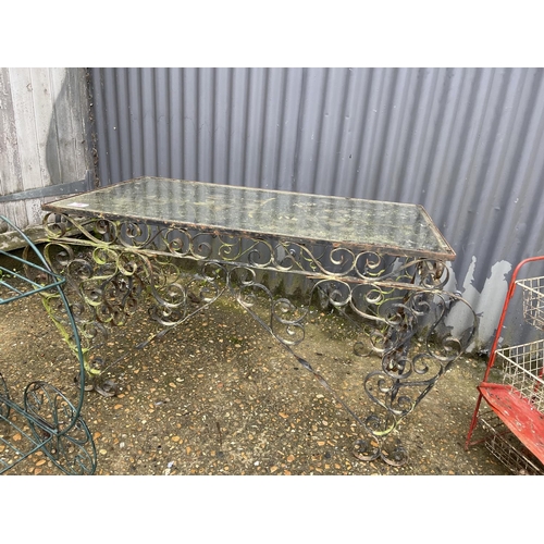 16 - A metalwork table with glass top together with a wirework trolley and a veg rack