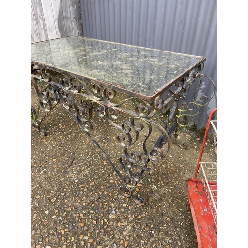 16 - A metalwork table with glass top together with a wirework trolley and a veg rack