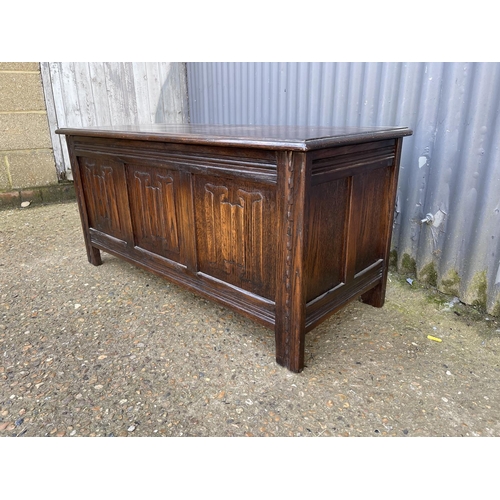 170 - A repro oak three panel coffer 107cm wide