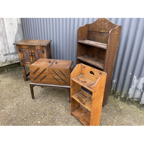 172 - An oak cupboard, an oak sewing box and two oak bookcases