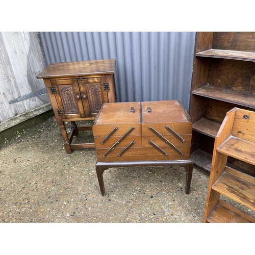 172 - An oak cupboard, an oak sewing box and two oak bookcases