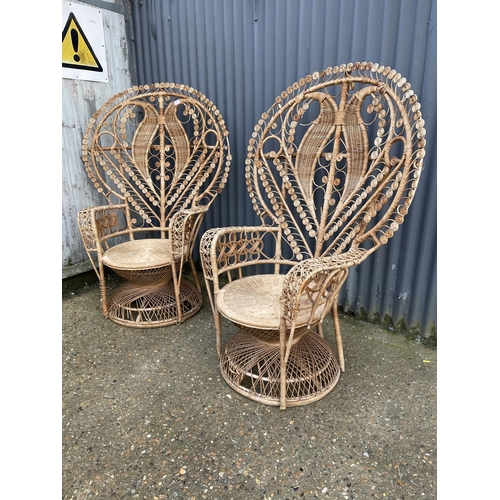 181 - A pair of large wicker 'peacock' chairs with heart shape to the back