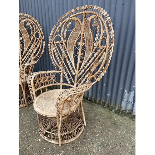 181 - A pair of large wicker 'peacock' chairs with heart shape to the back