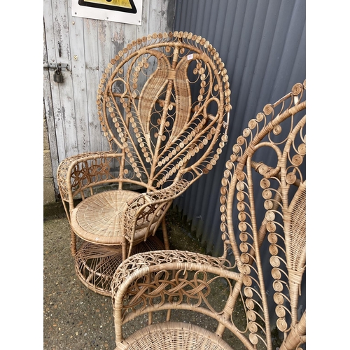 181 - A pair of large wicker 'peacock' chairs with heart shape to the back