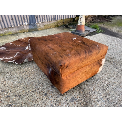 187 - Cow hide ottoman together with cow hide rug