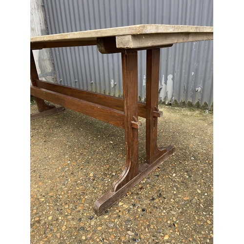 20 - A refectory style dining table with pine top and oak stretcher base 180x66x79