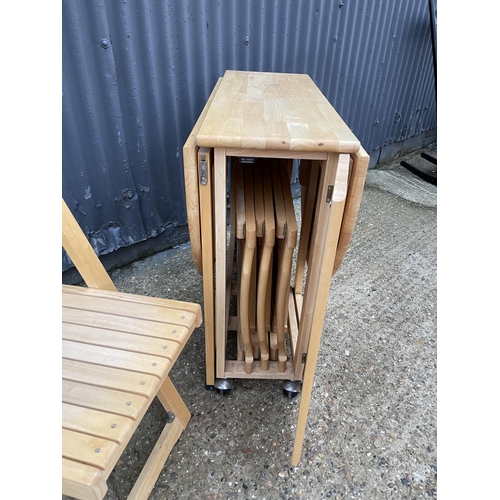 202 - A modern beech wood hideaway kitchen table and four chairs