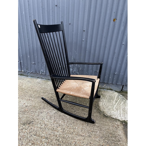 207 - A danish design black painted rocker chair with rush seat