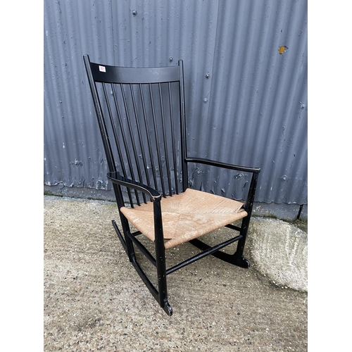 207 - A danish design black painted rocker chair with rush seat