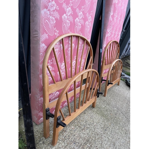 209 - A pair of early ercol light elm single bed frames with drop in divan bases