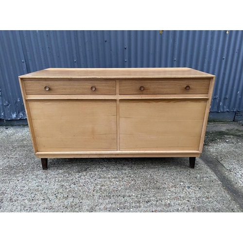 210 - A mid century teak sideboard by GORDON RUSSELL, labelled to the reverse RUSSELL OF BROADWAY 140x40x8... 