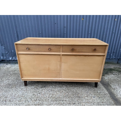 210 - A mid century teak sideboard by GORDON RUSSELL, labelled to the reverse RUSSELL OF BROADWAY 140x40x8... 