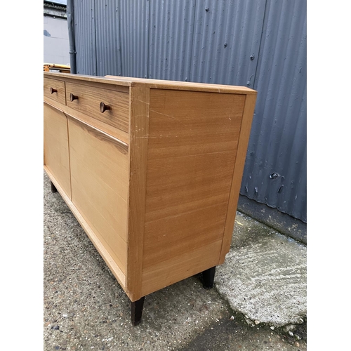 210 - A mid century teak sideboard by GORDON RUSSELL, labelled to the reverse RUSSELL OF BROADWAY 140x40x8... 