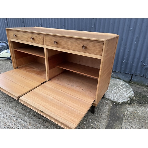 210 - A mid century teak sideboard by GORDON RUSSELL, labelled to the reverse RUSSELL OF BROADWAY 140x40x8... 