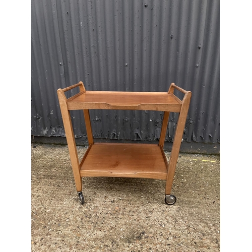 211 - A mid century teak tea trolley labelled JOHN FIRTH HONEYBOURNE