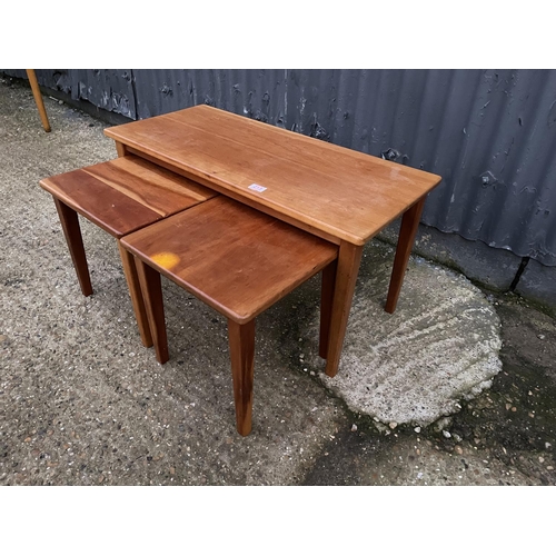 213 - A teak nest of three occasional tables