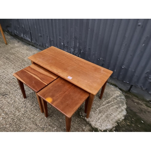 213 - A teak nest of three occasional tables