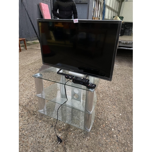 214 - A Panasonic tv on clear glass stand with remote