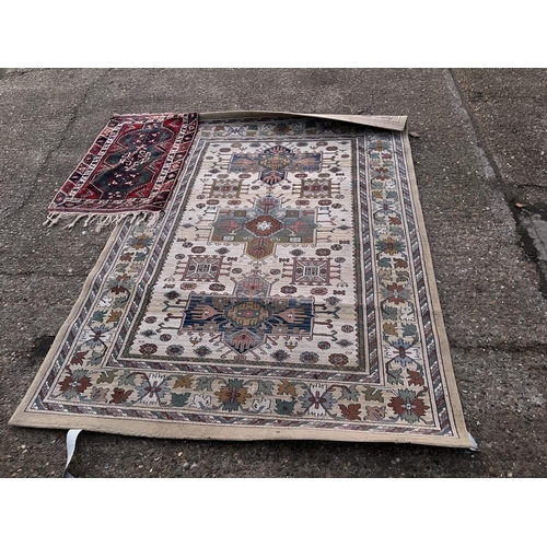 215 - A large pattern carpet together with a small red rug